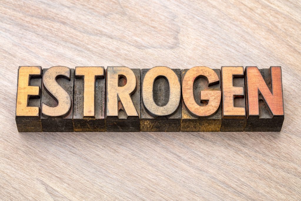 The word "estrogen" carved on wood