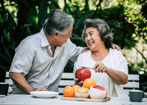 Elderly couple eating some fruit